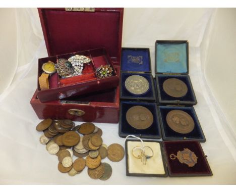 A box containing assorted medals and medallions to include a "Woolwich and Sandhurst Athletics Awarded to H L Weathered Crick