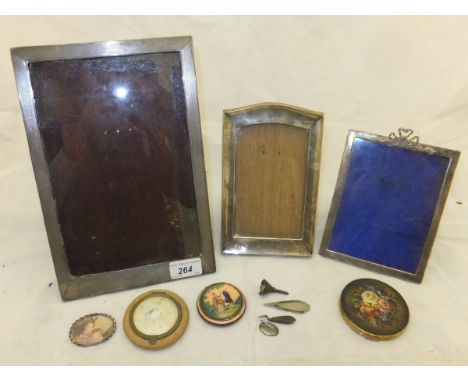 A large early 20th Century silver photograph frame with engine turned decoration, together with a smaller early 20th Century 