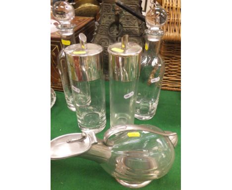 Two decanters in the manner of Dartington, a cylindrical flask with electro-plated top marked "Vodka" and another similar mar