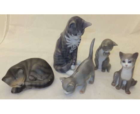 A large Royal Copenhagen figure of a cat, No'd. 655 to base, a collection of three Royal Copenhagen kittens, No'd. 515, 516 a