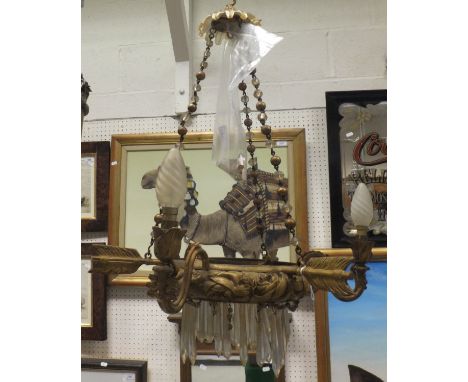 An early 20th Century gilt metal and glass hanging ceiling light of three branches with feathered arrow decoration, 42 cm dia