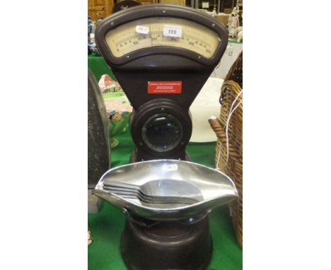 A set of bakelite cased 1lb shop scales with sweet pan and four scoops, and a wrought iron wall mounted storm lantern with gl