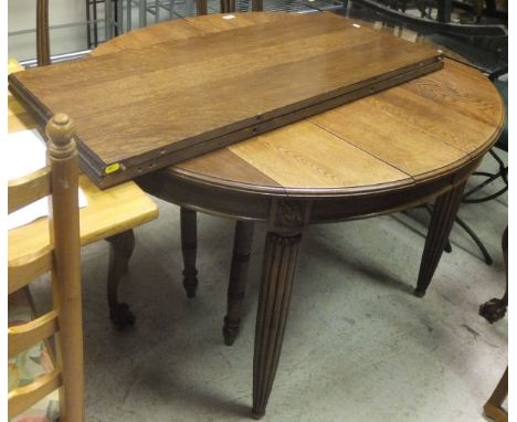 An oak oval draw leaf dining table, with two extra leaves, a set of six oak framed dining chairs with cabriole front legs, an