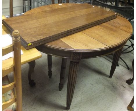 An oak oval draw leaf dining table, with two extra leaves, a set of six oak framed dining chairs with cabriole front legs, an