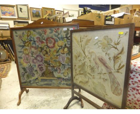 A large beech framed fire screen with floral woolwork panel, together with a mahogany fire screen with embroidered panel depi
