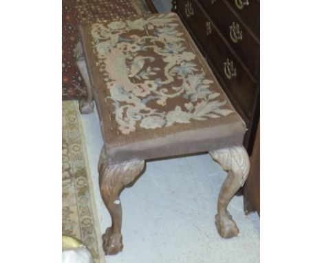 A circa 1900 needlework upholstered dressing stool of shell carved cabriole legs to claw and ball feet