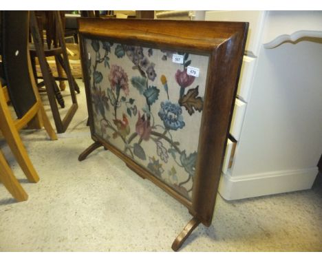 A 19th Century rosewood framed fire screen with long stitch panel depicting flowers and parrot