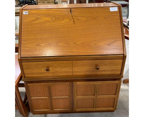 A mid-20th century teak bureau, the fall front opening to pigeon holes and a drawer, single long drawer below, to the base tw