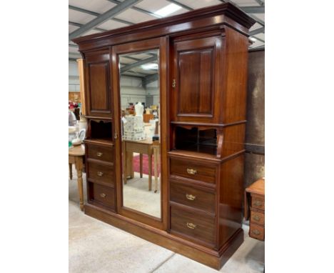 A Victorian mahogany wardrobe/cupboard, with single central mirrored door, flanked on either side by a cupboard with single p