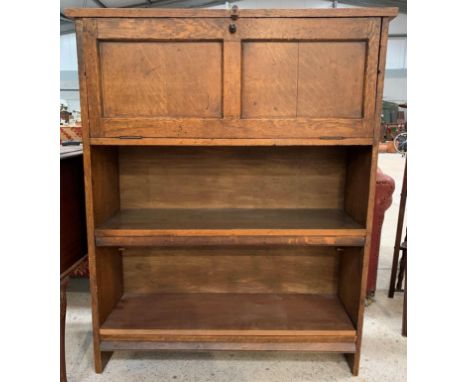 A 20th century stained oak unit, the fall front with panel moulding, and two adjustable shelves below, one shelf and the bott