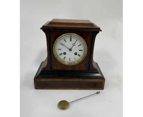 A late 19th century French eight day walnut veneer and ebonised mantel clock striking on a bell, with a white enamel dial and