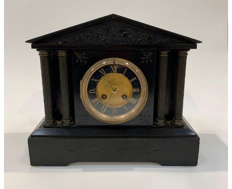 A Victorian mantel clock in black slate architectural case, hour and half hour striking on a gong, 27cms high 31.5cms wide. V