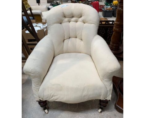 A Victorian upholstered button back chair with turned front supports and on original casters. Viewing/collection at West Wood