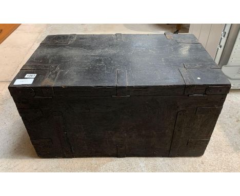 A black painted metal bound wooden travelling trunk having side metal carrying handles and with key, 49cms x 79.5cms x 42cms 
