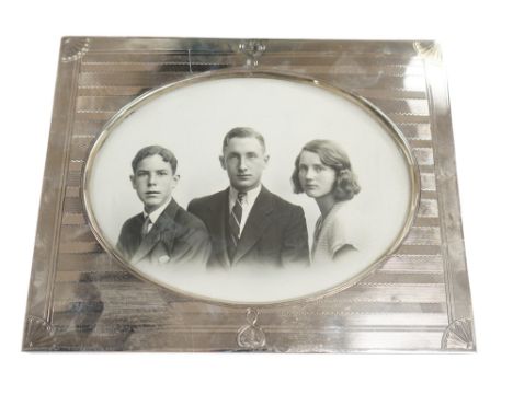 An Edwardian part engine turned silver mounted photograph frame, William Comyns, London, 1907, lacking support arm, width 26.