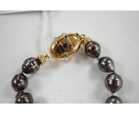 A  modern single strand graduated Tahitian baroque cultured pearl necklace, with cabochon set yellow metal clasp, 48cm. Condi