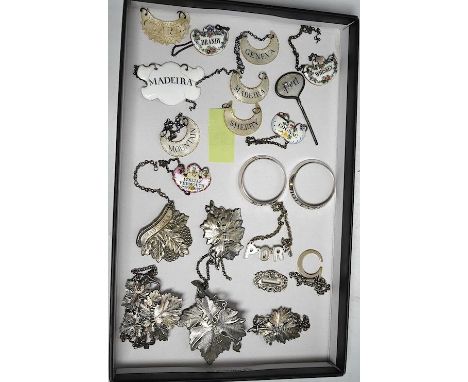 A collection of twenty one mixed novelty wine and spirit labels; six mother-of-pearl, five enamel, five plated leaf wine labe