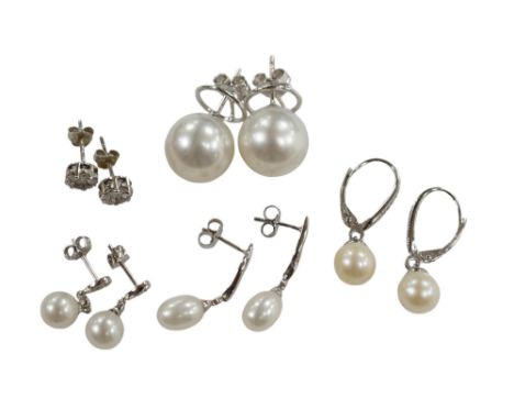 Three assorted modern pairs of 9ct, cultured pearl and diamond chip set earrings, a similar diamond cluster pair and a pair o