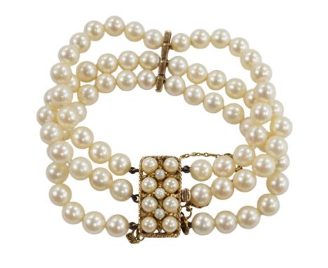 A triple strand cultured pearl necklace, with 9ct and cultured pearl clasp and spacer, 18cm. Condition - fair