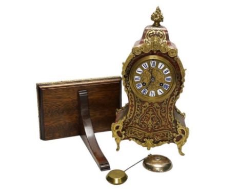 A Louis XV style red boulle eight day mantel clock, with bracket and pendulum, clock 30cm high. Condition - fair, not tested