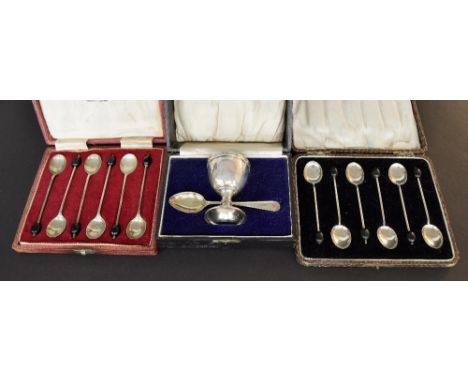 Two cased sets of six silver coffee bean spoons, dated 1924 and 1973 (Mappin & Webb); also a cased silver christening spoon a