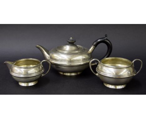 Matched three piece bachelor silver tea service, of squat ovoid form with a central reeded girdle, Birmingham 1905 and 1912, 