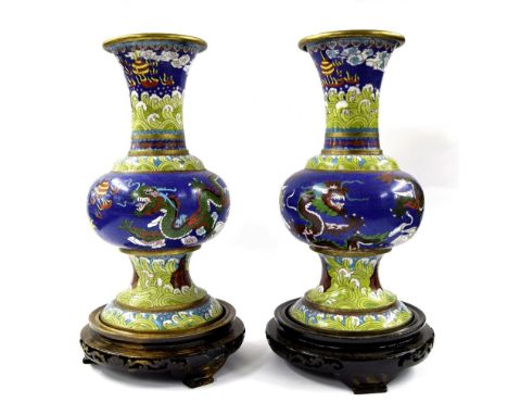 Pair of Chinese cloisonne vases, decorated with five claw dragons chasing a flaming pearl, in yellow and blue, 15" high, upon