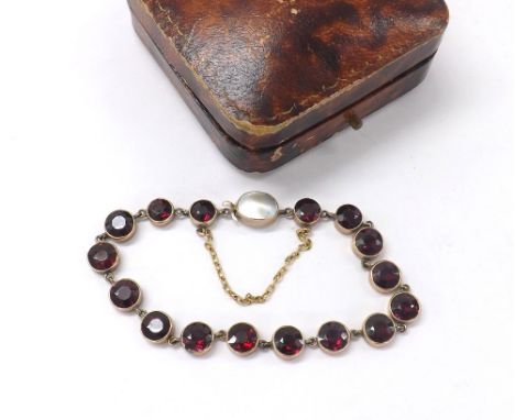 Attractive gold garnet set bracelet with an oval mother of pearl set clasp, with safety chain, 9.6gm, 6.25" long approx, boxe