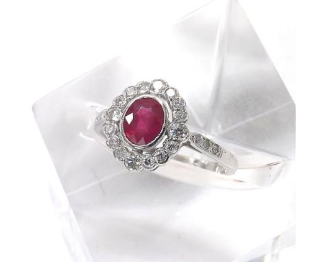 18ct white gold oval ruby and diamond cluster ring, the ruby 1.13ct approx, in a surround of round brilliant-cut diamonds, 0.