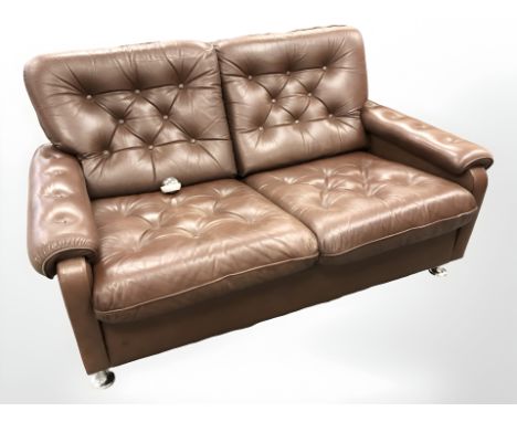 A late 20th century Danish button brown leather two seater settee on chrome feet, width 137 cm 