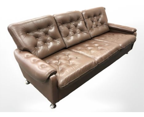 A late 20th century Danish button brown leather three settee seater on chrome feet, width 190 cm 