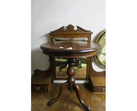 A MAHOGANY OCCASSIONAL TABLE, the oval top above a baluster column with tripod support.