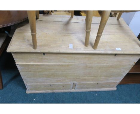 A PINE TRUNK, with hinged top and two short drawers on moulded base,68cms x 105cms x 53cms.