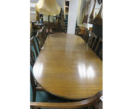 A REGENCY STYLE MAHOGANY DINING TABLE the rectangular top with rounded ends and one loose leaf on twin tripod supports  75cm 