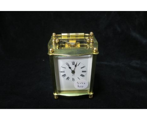 A BRASS CARRAIGE CLOCK, with enamel dial.
