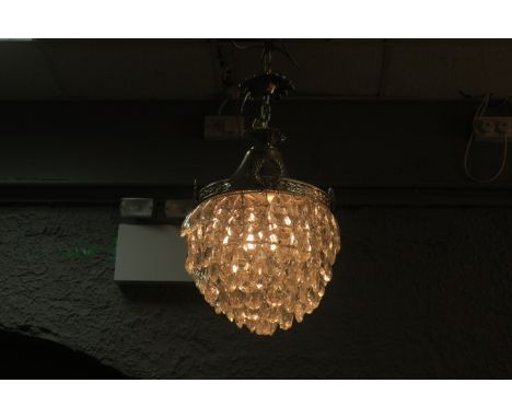 A CONTINENTAL SILVERED AND CUT GLASS BASKET SHAPED CENTRE LIGHT, hung with lozenge shaped drops.