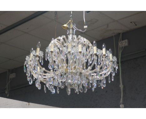 A CONTINENTAL STYLE EIGHTEEN LIGHT CUT-GLASS CHANDELIER, the brass frame with bulbous cut glass bowls issuing inverted scroll