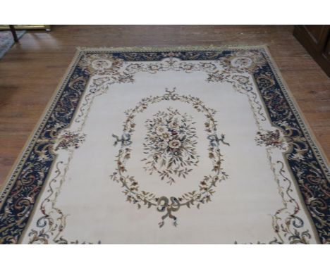 A RUG, the beige ground with central floral panel within a conforming border,208cms x 200cms.