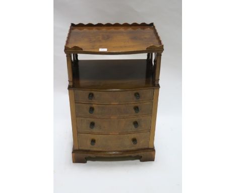 A BURR WALNUT VENEERED SIDE CABINET the rectangular bowed top with raised waved gallery on column supports with an open shelf