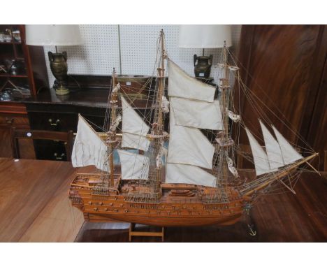 A WOODEN FRAMED SHIPS MODEL, complete with linen sails and ropes with metal anchors 90cms x 106cms