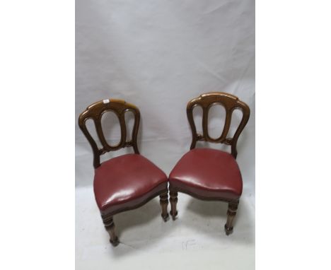 A SET OF SIX 19TH CENTURY MAHOGANY CARVED DINING ROOM CHAIRS, the shaped backs with open oval panel above a red leather uphol