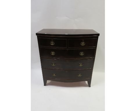 A 19TH CENTURY MAHOGANY BOWED CHEST OF DRAWERS the plain top above two short and three long cock beaded drawers with oval bra