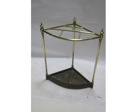 A BRASS FRAMED CORNER SHAPED STICK STAND, of tubular form with compartmented open work panel above a metal liner 58cms x 50cm