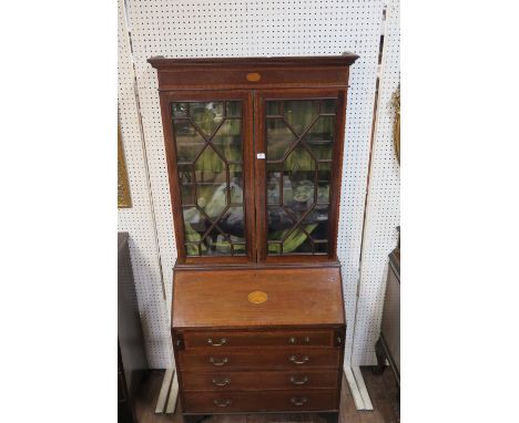 A GEORGIAN MAHOGANY AND SATINWOOD BANDED BUREAU BOOKCASE the moulded cornice above the recessed frieze centred by an oval tab