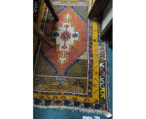 A BOKHARA WOOL RUG, the wine and light yellow ground with central floral panel and conforming border.