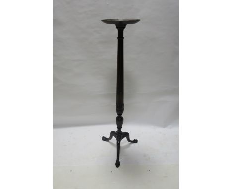 A MAHOGANY TORCHERE, 19th CENTURY, the circular dished top above a cylindrical and carved column on tripod support,129cms hig
