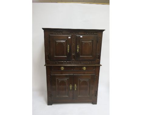 AN 18TH CENTURY OAK CARVED DRESSER the rectangular top with a pair of panelled doors above the outset base with one long draw