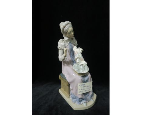 A LLADRO FIGURE, modelled as a female shown seated,30cms high.