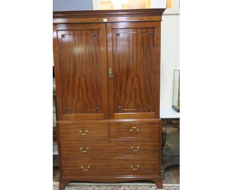 A GEORGIAN STYLE MAHOGANY CABINET the moulded cornice above a pair of panelled doors decorated with flower heads the outset b