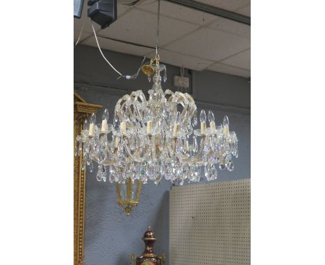 A CONTINENTAL STYLE EIGHTEEN LIGHT CUT-GLASS CHANDELIER, the brass frame with bulbous cut glass bowls issuing inverted scroll